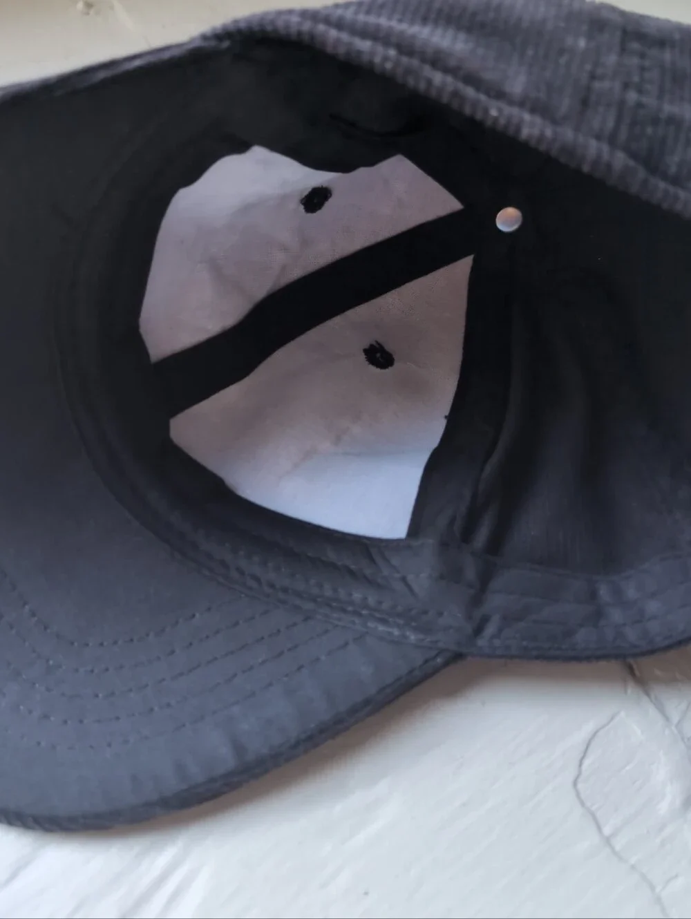 Black corduroy baseball cap with adjustable strap